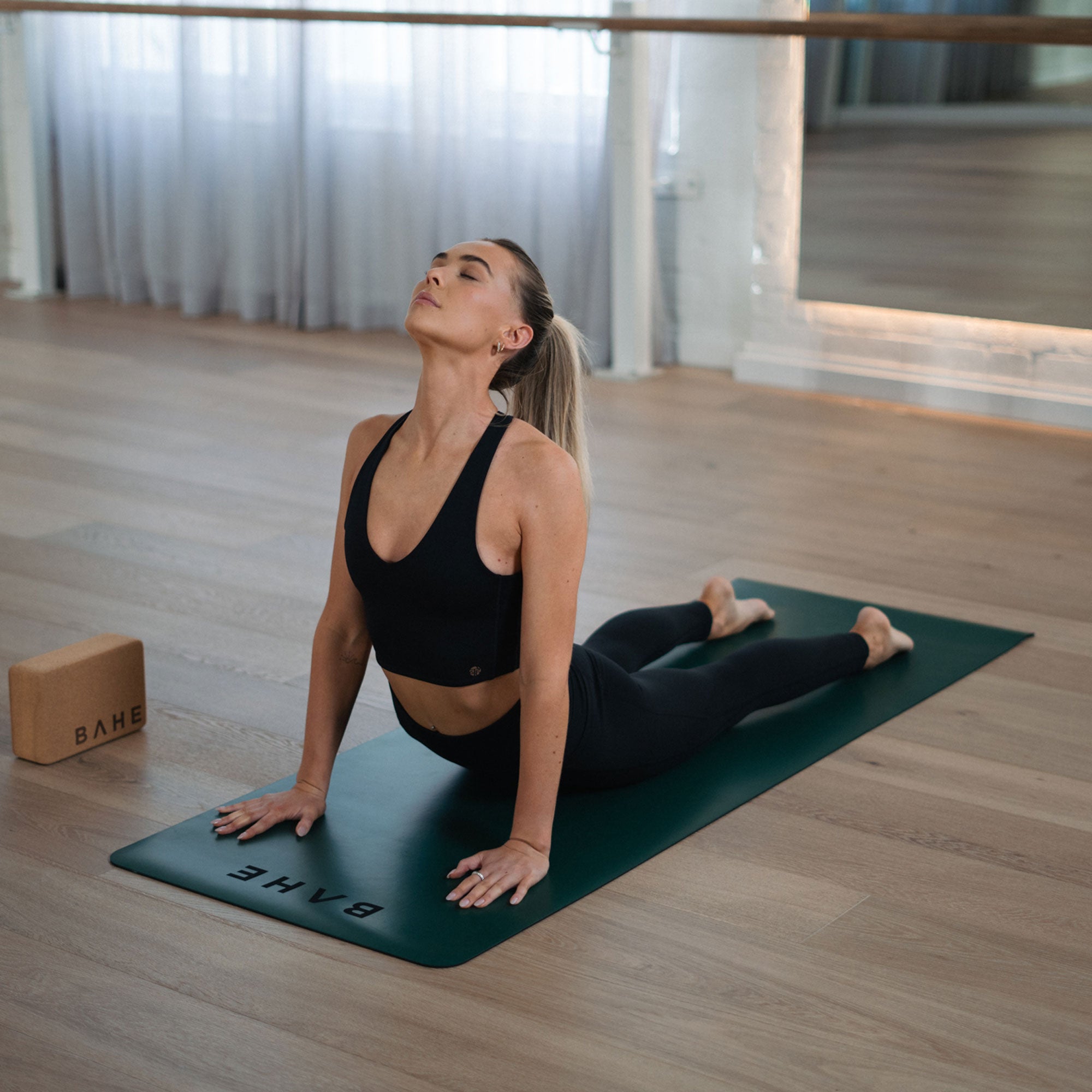 Black crop top for Pilates and yoga — BAHE’s breathable, double-lined design with sculpted support and stylish cross back.